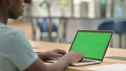 Adult Types on Green Screen Laptop in Office