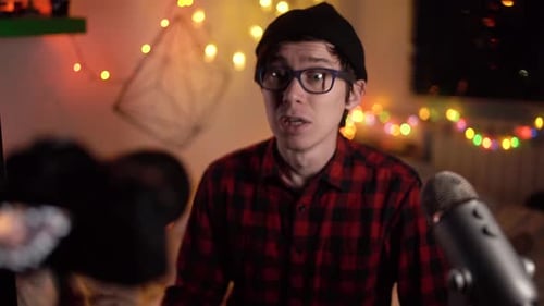 Young Adult Vlogger Talking to Camera With Microphone