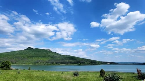 Lake and Mountain View with Clouds Passing