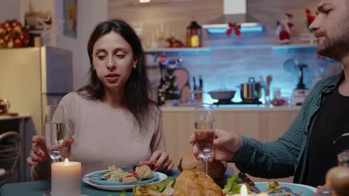 Couple Toasting During Christmas Candlelit Dinner