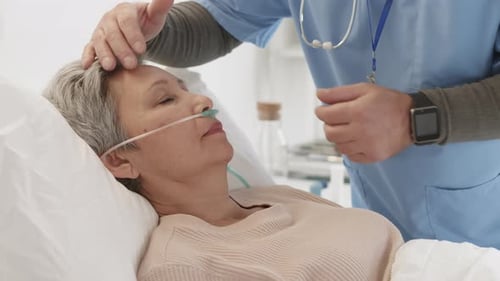 Medical Staff Adjusts Nasal Cannula on Senior Patient