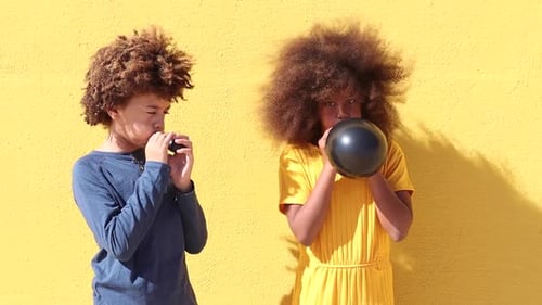 African American kids having fun with balloons