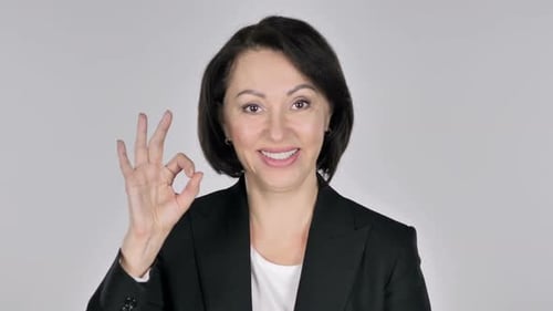 Smiling Woman Gives OK Hand Gesture