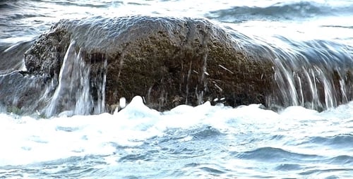 Waves Crashing Over Ocean Rock on a Sunny Day