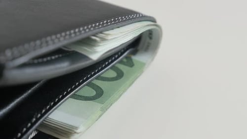 Euro banknotes in bi-fold money case close-up 3840X2160 UltraHD tilting footage - Wad of money in bl