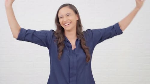 Excited Woman Jumping with Joy and Arms Raised