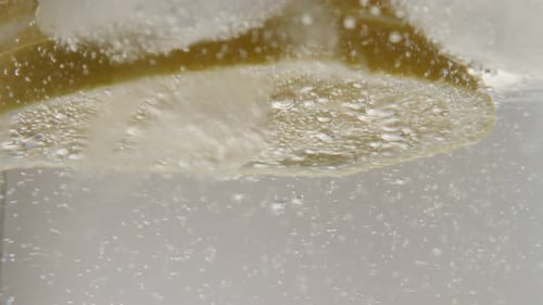 Highly carbonated water and ice cubes in the glass close-up 4K 2160p 30fps UltraHD footage - Lemon s