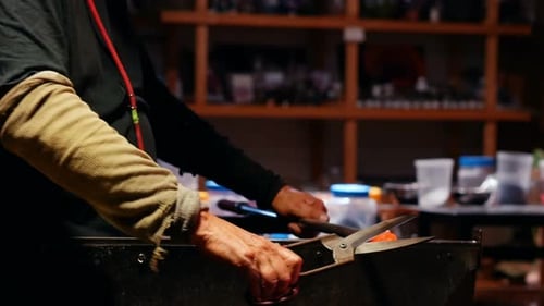 Glass Blower Cutting Hot Glass with Shears