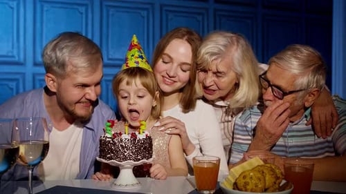 Family Celebrates Child's Birthday at Indoor Table