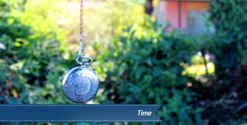 Silver Pocket Watch Swinging Gently Outdoors