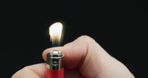 Hand lighting a lighter