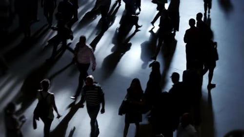 Pedestrians Walking on Crowded Street in Metropolis