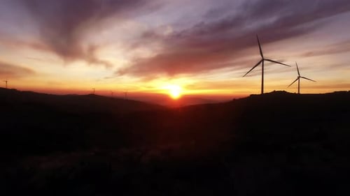 Wind Turbines Silhouetted Against a Dramatic Sunrise
