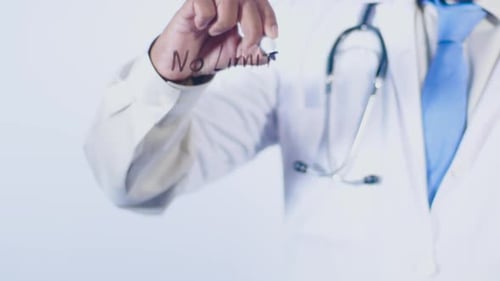 Doctor Writing 'No Limits' on Clear Surface