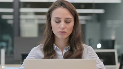 Woman Experiences Neck Pain While Using Laptop