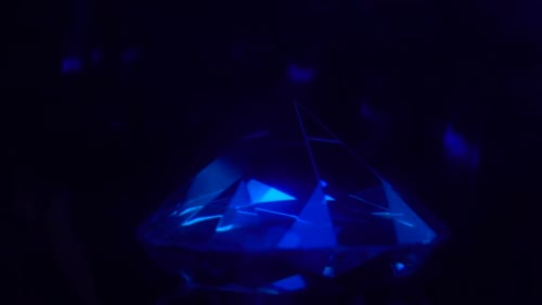 Crystal Clear Brilliant Cut Diamond Standing on Its Point Rotates