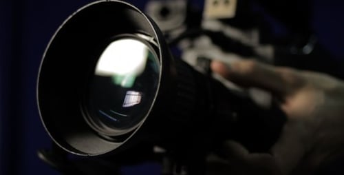 Camera Lens Close Up with Hand Adjusting Focus