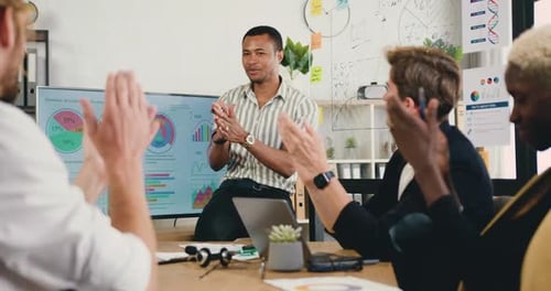 Team Applauding Presentation During Meeting in Office