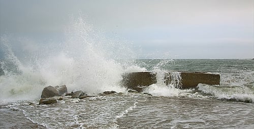Powerful Waves Crashing on Concrete Barrier