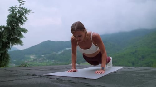 Sporty Woman is Doing Pushup and Jump in Park in Hills Fitness Workout Outdoors