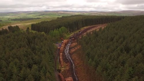 Forestry and logging operations taking place in the highlands of Scotland using large industrial mac