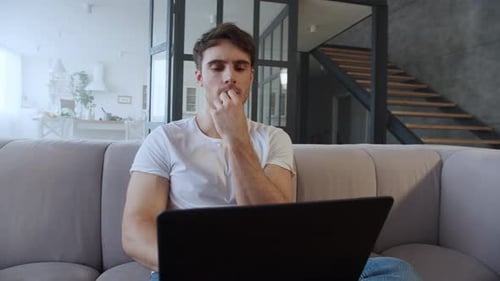 Man Working on Laptop Computer at Home