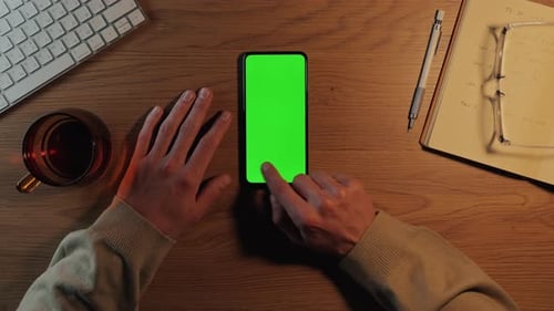 Man Sliding with Finger on Chroma Key Screen of Smartphone