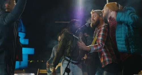 Live Band Performing Outdoors at Night Concert