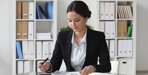 Focused Businesswoman Analyzing Data in Modern Office