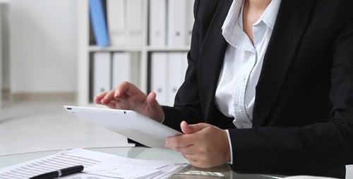 Woman Working with Tablet in Bright Office