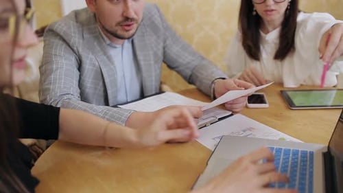 Team Collaborating at Meeting Analyzing Business Documents