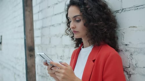 Young Woman Using Mobile Phone in City