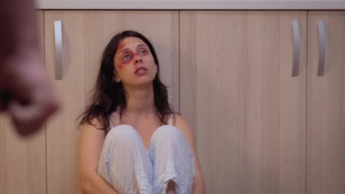 Injured Woman With Man With Clenched Fist