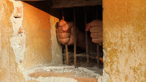 Jail Cell with Hands on Bars, Historical Prison