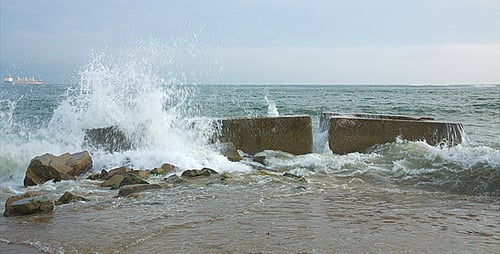 Ocean Waves Crashing Against Coastal Rock Barrier