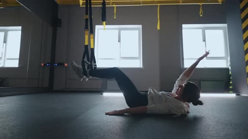 Crossfit Fitness TRX Training Exercises at Gym Woman Pushup Workout