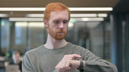 Young Adult Man Using Smartwatch in Office