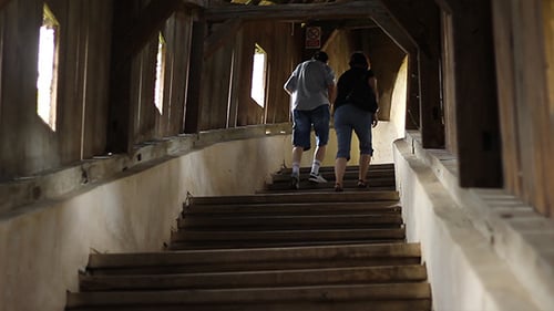 Man and Woman Walk Covered Bridge Stairs