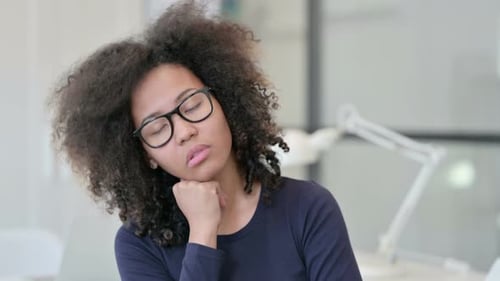 Woman with Glasses Asleep at Desk