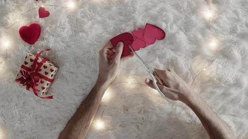 Cutting Red Paper Hearts with Scissors