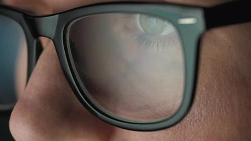 Close Up of Person Wearing Glasses Reflecting Screen