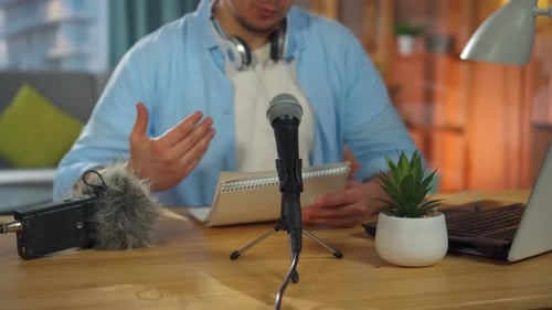 An Unrecognizable Person Records an Audio Podcast or Conducts an Internet Stream While Sitting at