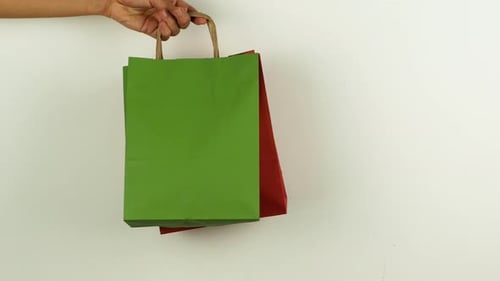 Hands Exchanging Shopping Bags