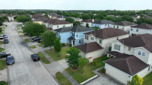 Two story family homes along street in USA. Aerial view. Residential community housing development i