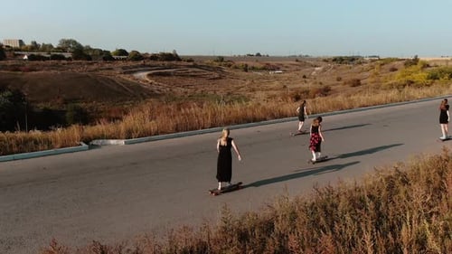 Trendy Youth Sport, Longboarding Women in Dresses During Sunset