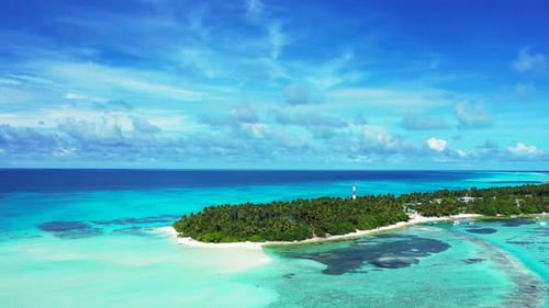 Wide angle flying copy space shot of a sandy white paradise beach and blue water background in color