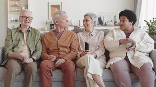 Smiling Seniors Relaxing Together on Couch