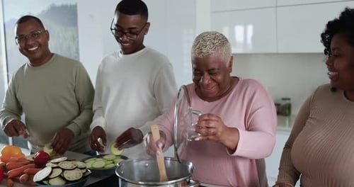 Adults Preparing Meal Together in Modern Kitchen
