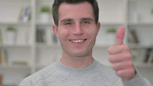 Smiling Young Adult Gives Thumbs Up Close Up