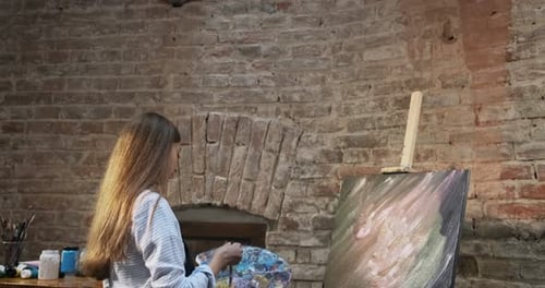 Talented Innovative Pretty Female Artist Draws with Brush on the Canvas. Contemporary Young Woman